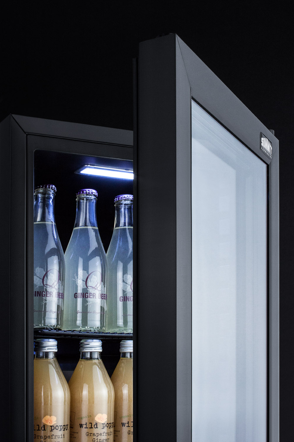 Compact commercial beverage center designed for the display and refrigeration of beverages, with glass door, lock, and black cabinet